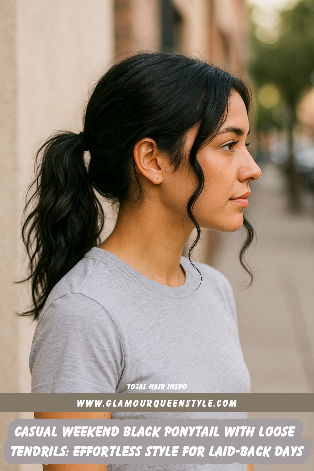 Woman wearing a relaxed black ponytail accented by soft, loose tendrils around her face; makeup is fresh and paired seamlessly with comfortable-chic outfit.