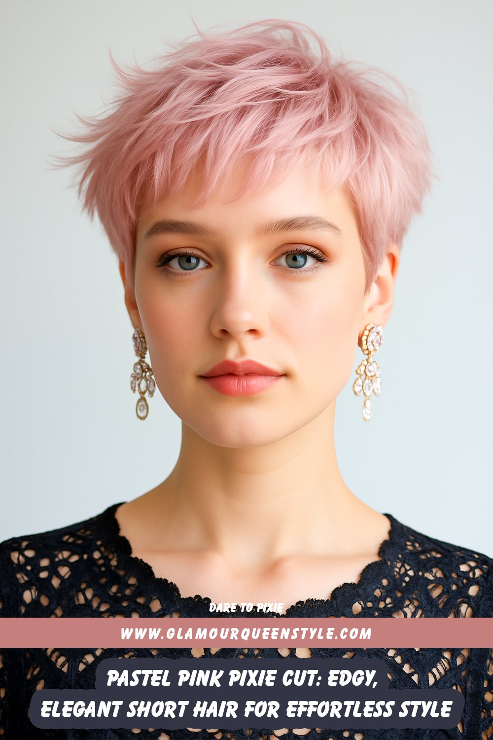Person sporting a pastel pink pixie cut; hair styled in textured layers with soft volume, complemented by bold earrings and chic tailored clothing.