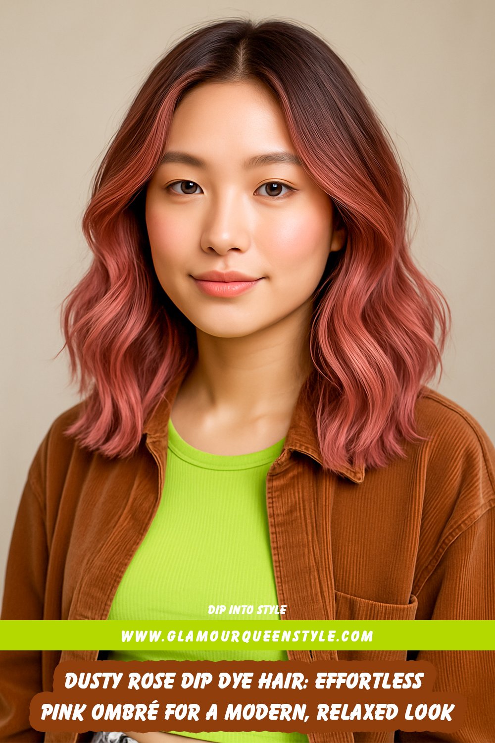 Person wearing long dark hair styled with dusty rose dip-dyed ends; muted pink seamlessly fades from the base, complemented by understated fashion and jewelry.
