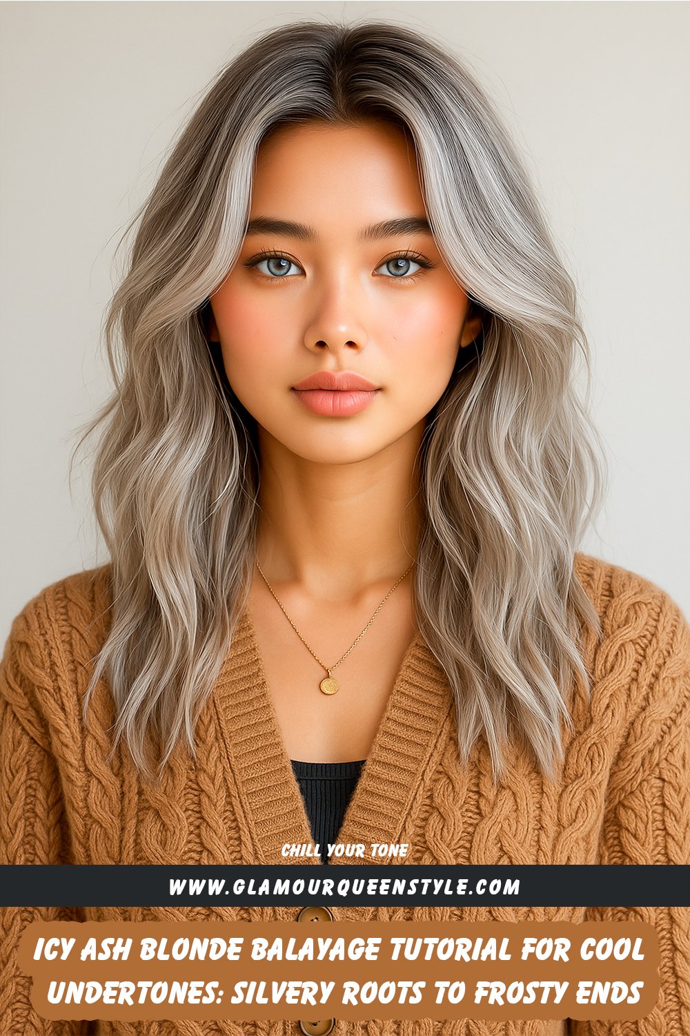 Close-up of long layered hair styled in icy ash blonde balayage; silvery roots blend seamlessly into frosty blonde tips on a woman with pale skin and cool undertones, wearing a neutral-toned sweater.