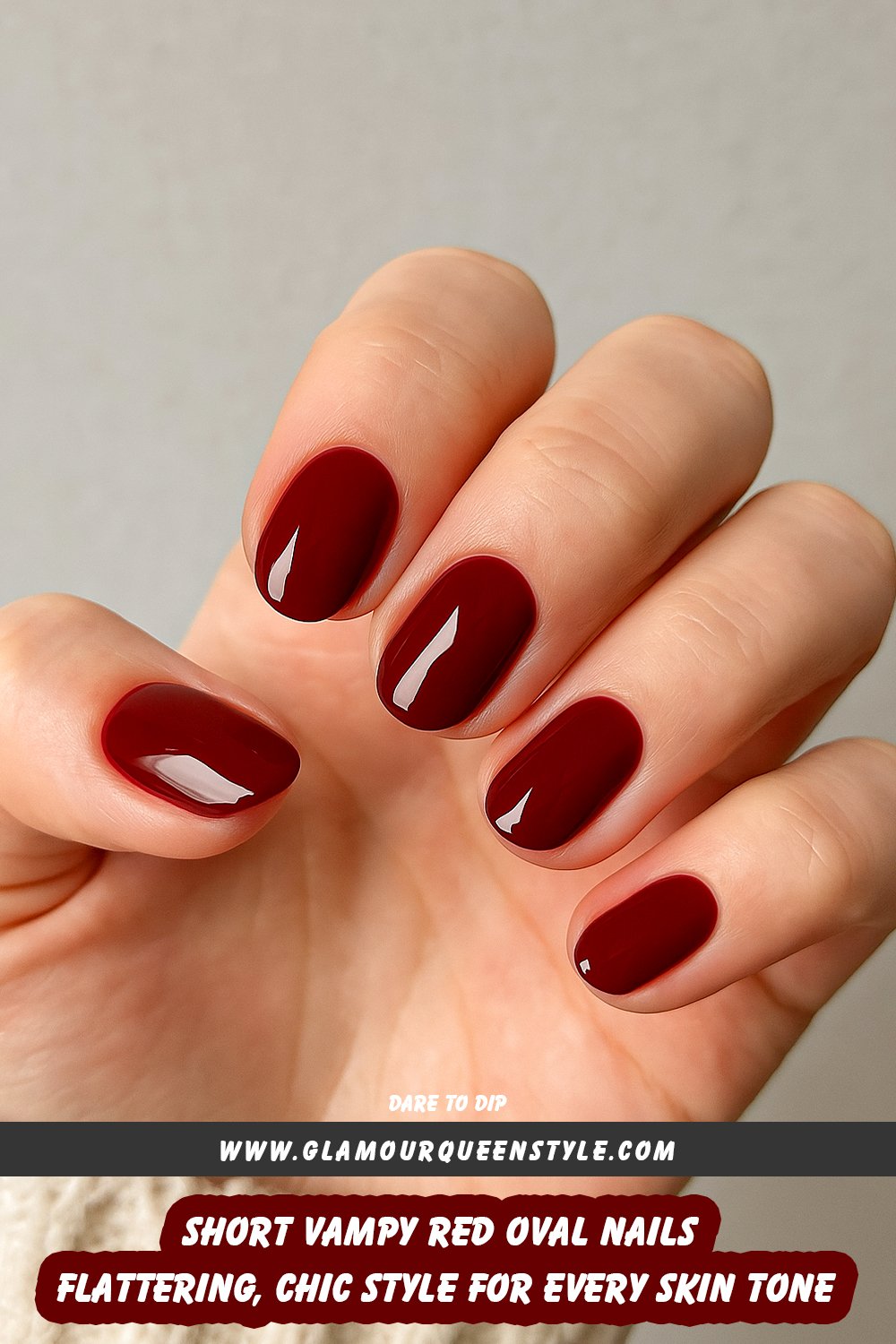 Hands featuring short, vampy red oval-shaped nails with no embellishments, perfectly matching and complementing various skin tones.