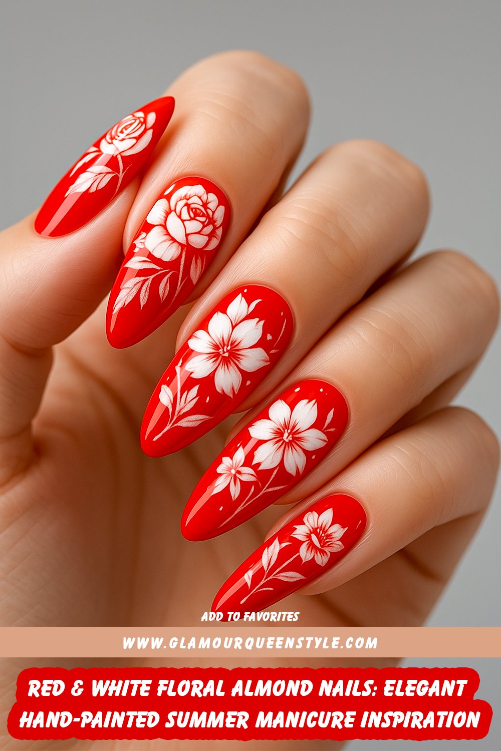 Almond-shaped nails painted in glossy red and white with delicate hand-painted flower designs create an elegant, feminine summer manicure.