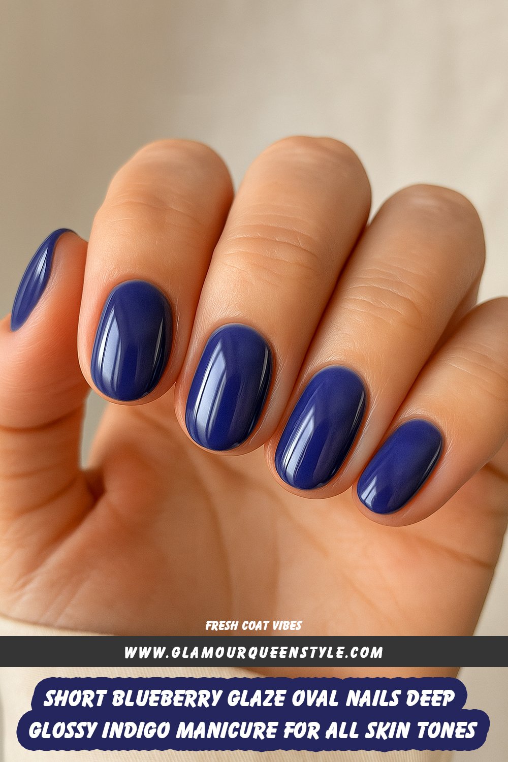 Close-up of hands with short, glossy indigo blue oval-shaped nails; nail color enhances different skin tones with its deep shine.