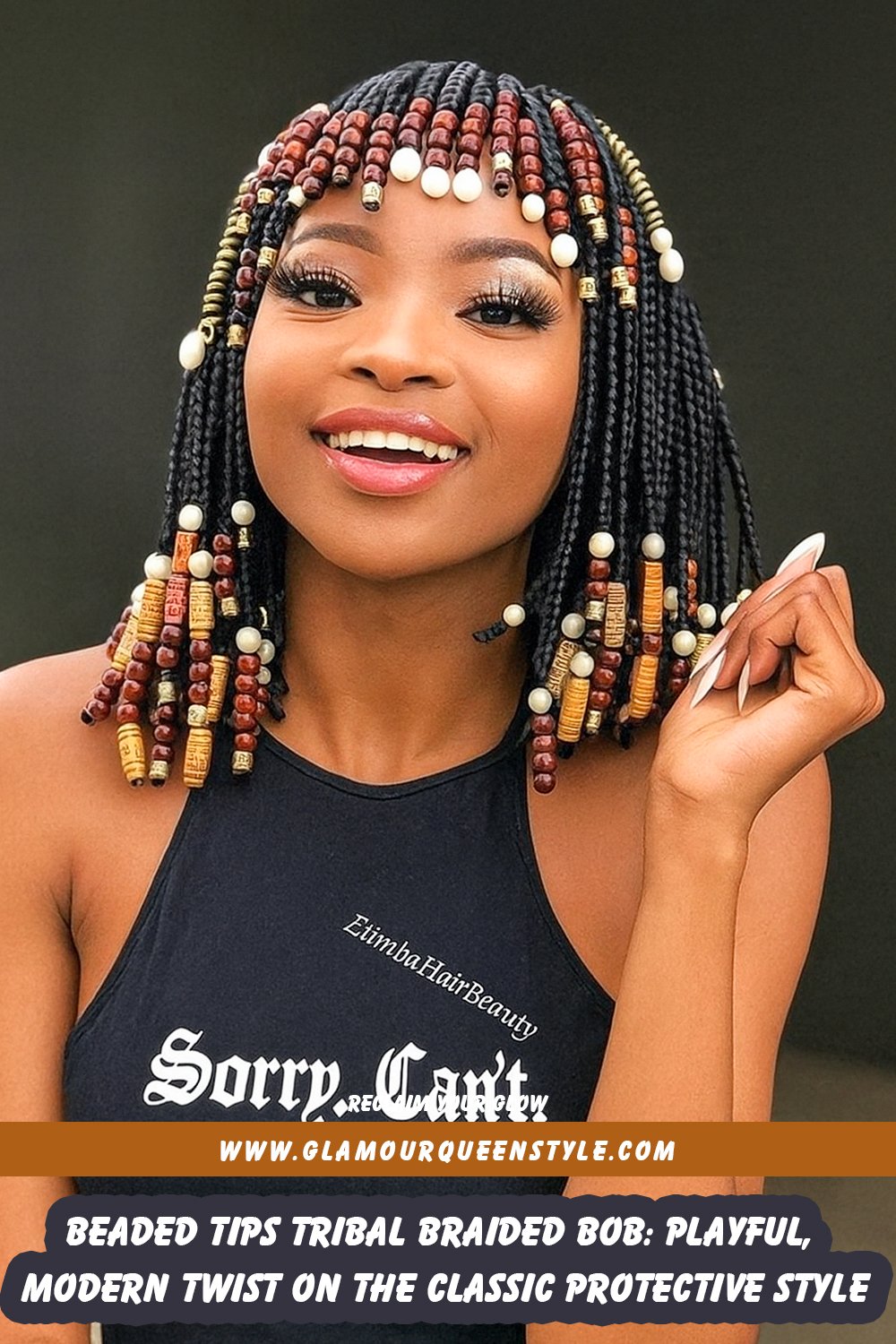 Woman wearing neatly braided bob haircut featuring braids tipped with decorative beads; styled in contemporary fashion that highlights facial features.