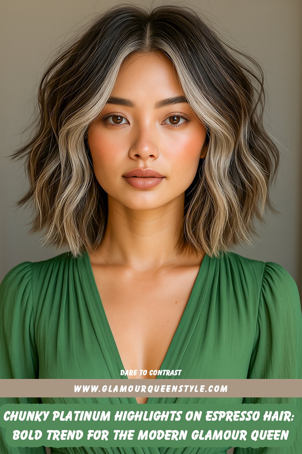 Woman with deep espresso brown hair featuring bold chunky platinum highlights concentrated along face-framing layers; styled in loose waves paired with subtle glam makeup, nude lipstick, and an elegant black blazer layered over a sage green blouse.