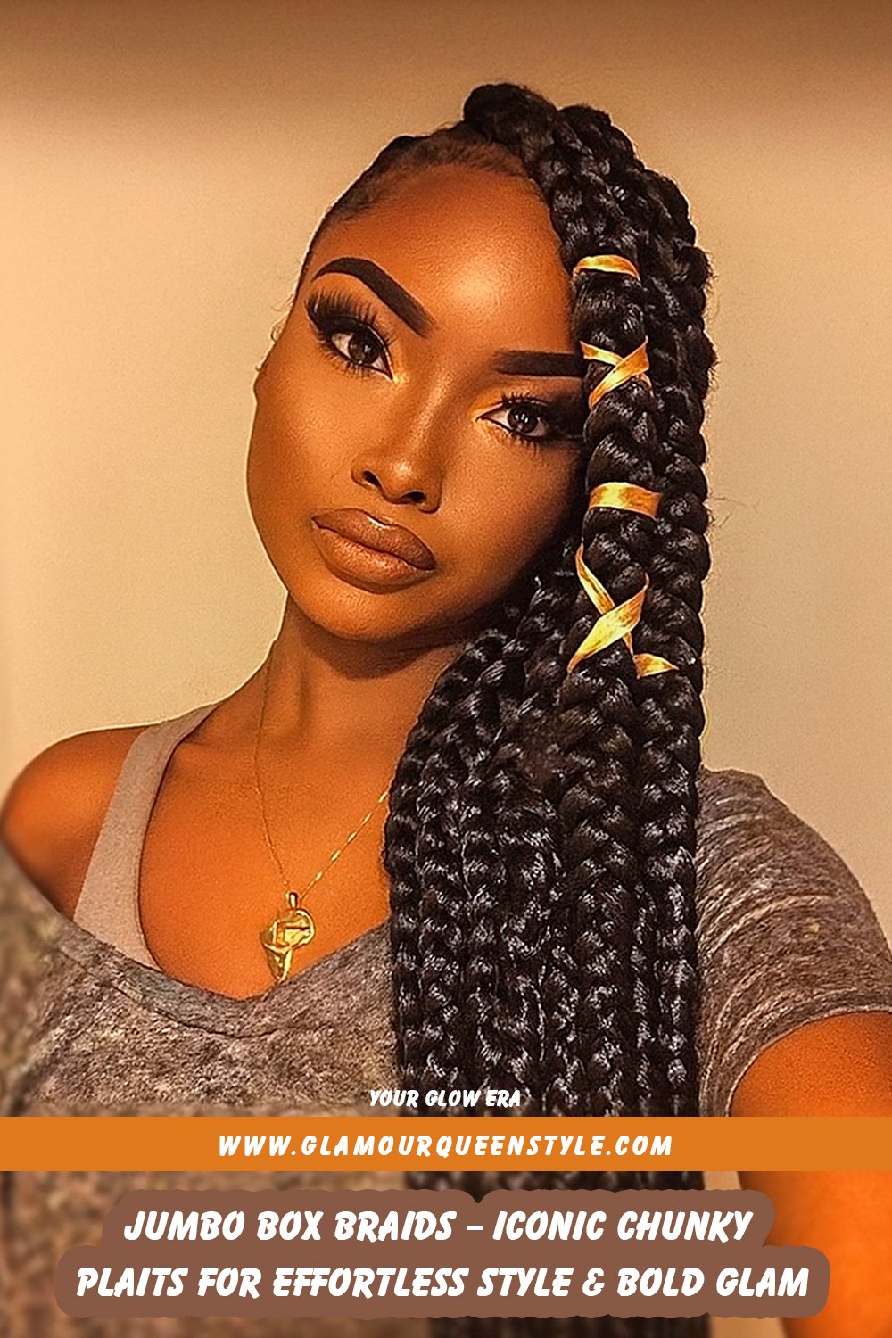 Woman wearing large, chunky jumbo box braids reminiscent of styles worn by Teyana Taylor and Rihanna; her hairstyle is coordinated perfectly with fashionable accessories.