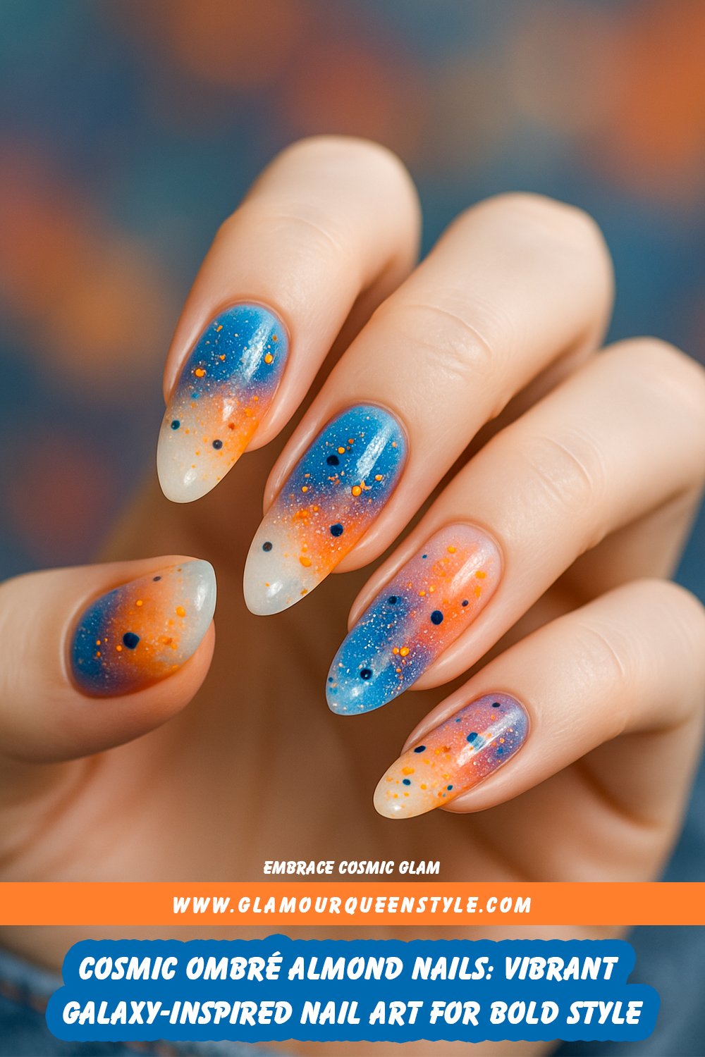 Almond-shaped nails featuring an ombré transition from white at the cuticle to vibrant shades of blue, orange, pink, and gold at the tips; decorated with multicolored glitter dots over a cosmic-inspired background.