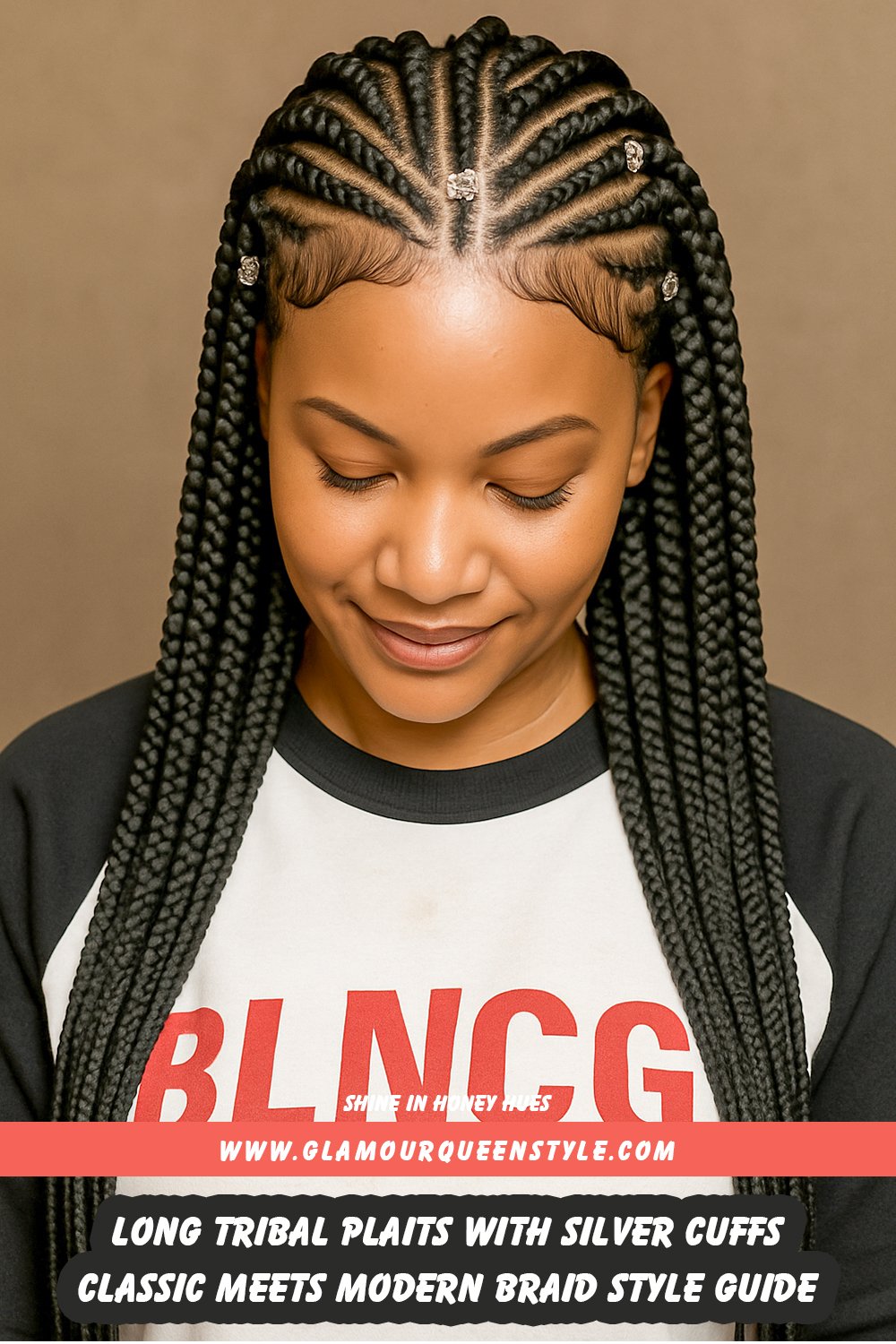 Long tribal plaits styled precisely with a thick center braid and accented by shiny silver cuffs for a striking blend of traditional design and modern details.