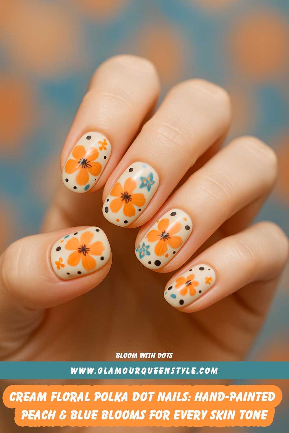 Nails painted soft cream; adorned with hand-painted peach-orange and blue flowers (outlined, dark centers), scattered black polka dots of various sizes, plus small orange accents—an elegant yet lively effect flattering every skin tone.