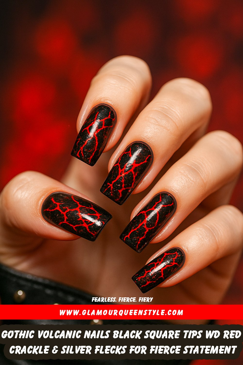 Long square-shaped jet black nails featuring intense red crackle patterns like molten lava veins; enhanced by subtle silver flecks for extra depth—striking on all skin tones.