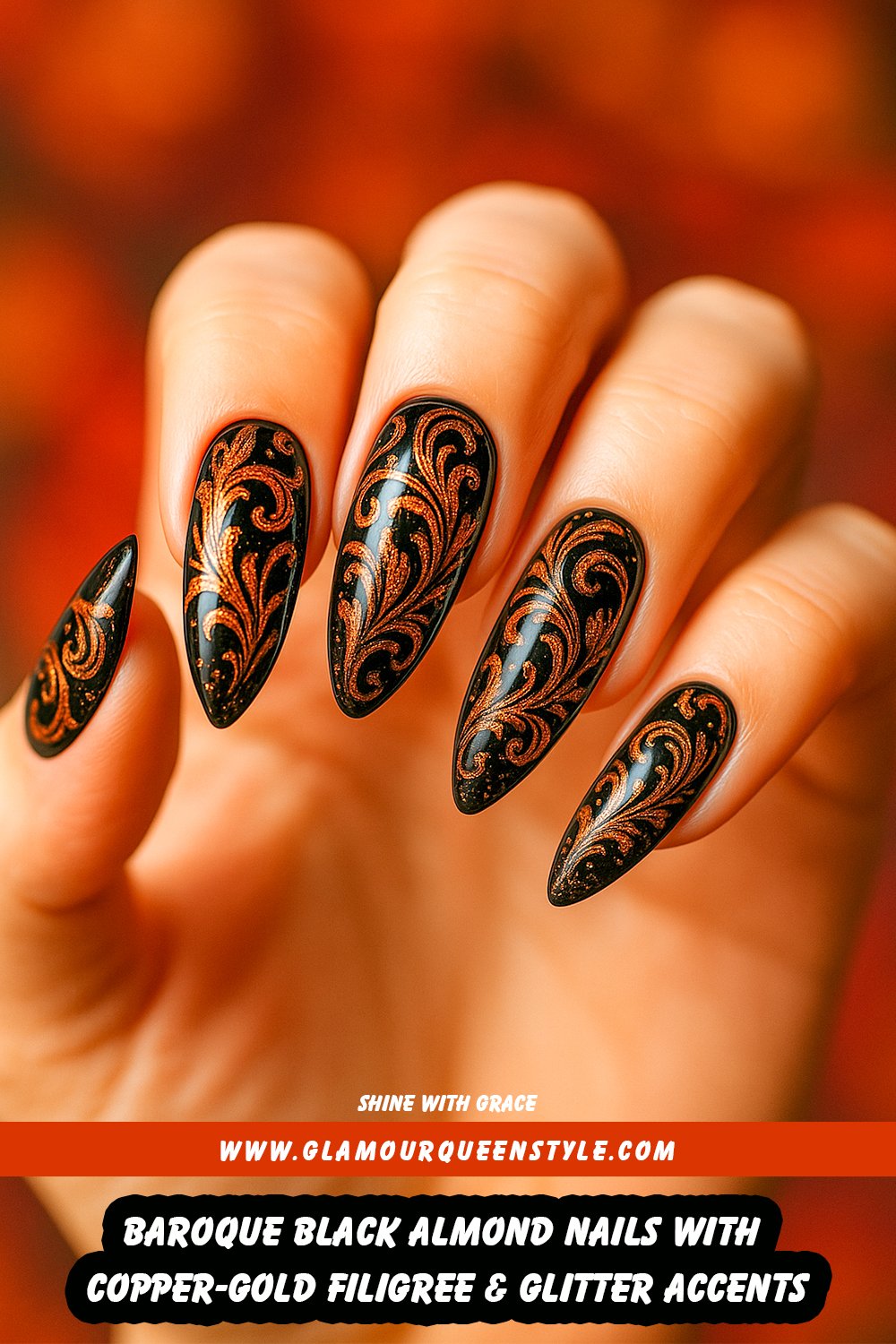 Long almond nails featuring a high-gloss black finish matched perfectly to skin tone, adorned with intricate copper-gold metallic swirls and detailed baroque filigree designs accented by sparkling glitter highlights.