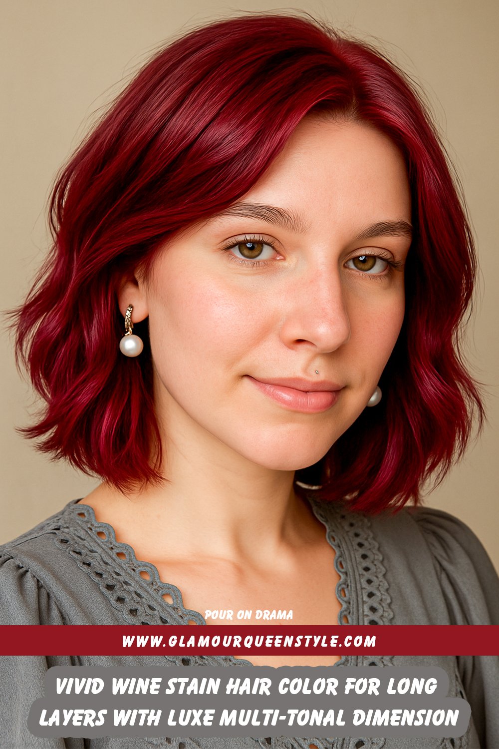 Long layered hair dyed in vivid wine stain hues blending deep red and purple tones, styled sleekly to showcase rich, multi-tonal dimension.