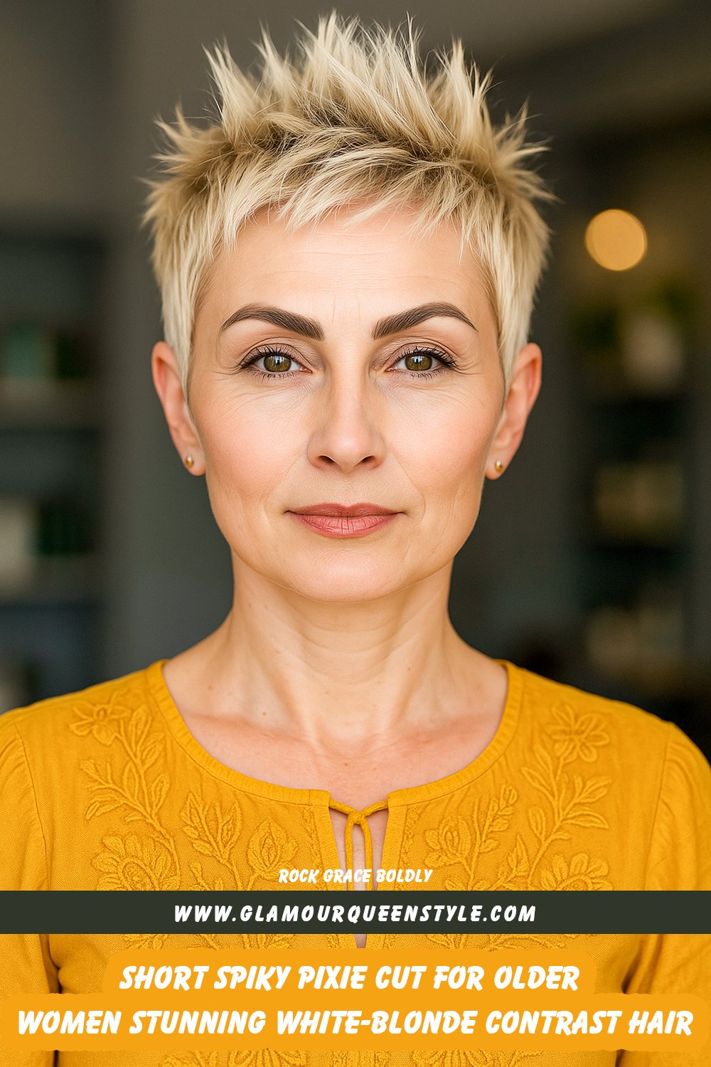 An older woman rocking a very short spiky pixie cut featuring white-blonde highlights at the front, styled alongside minimalist chic clothing.
